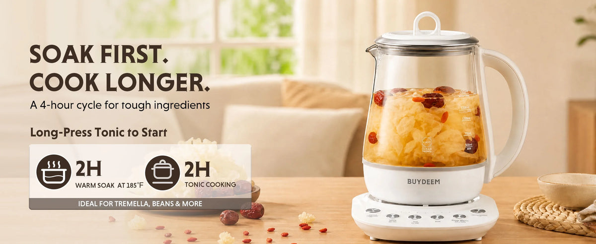 BUYDEEM K123 Multi-function Beverage Maker with a white base and silver lid, shown filled with fruit on a tabletop in a softly lit kitchen setting. Large promotional text on the left reads 'SOAK FIRST.