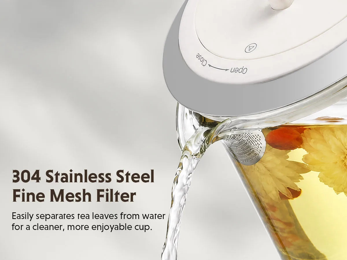 A close-up of a clear glass teapot pouring water over a fine mesh filter, with tea leaves visible inside. Text on the left reads '304 Stainless Steel Fine Mesh Filter' with a subtitle about separating tea leaves from water.