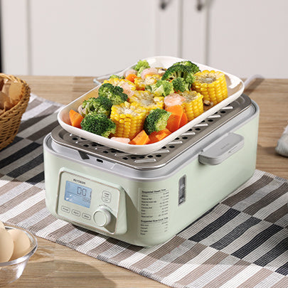 BUYDEEM's Food Steamer with vegetables on a kitchen counter
