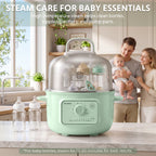 A mint green BUYDEEM steamer sits on a kitchen counter in a bright kitchen, with baby bottles inside and outside the steamer. A blurred family is visible in the background, and text at the top reads 'STEAM CARE FOR BABY ESSENTIALS'.