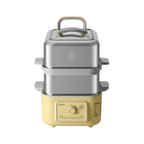 A yellow two-tier food steamer  with a brushed stainless steel upper pot and a cream-colored base, featuring a top handle and a control dial on the front.
